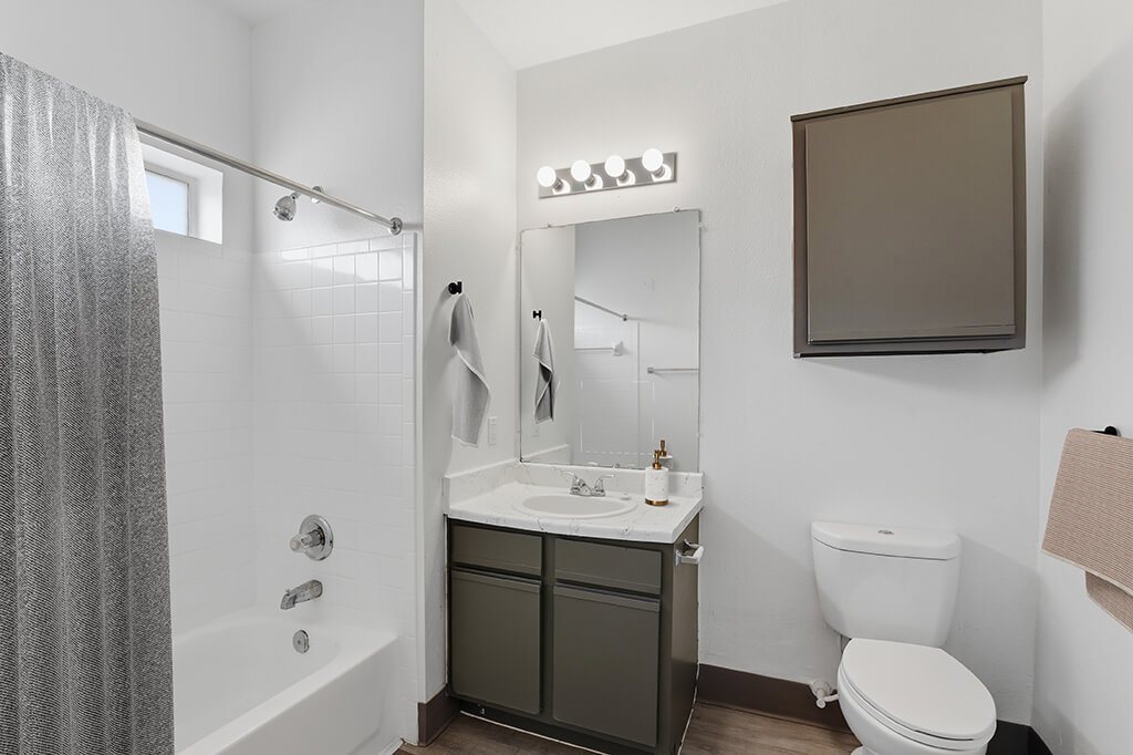 Bathroom with shower tub combo at Almeda Park Apartments in Houston TX